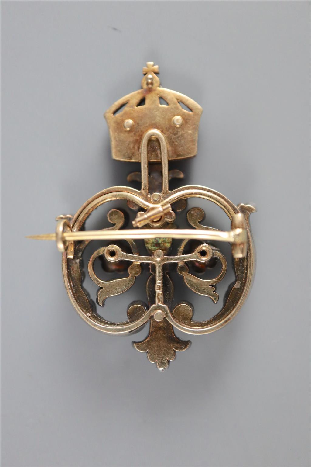 A late 19th/early 20th century Austro-Hungarian 580 standard gold and silver, rose cut diamond and enamel scroll brooch,